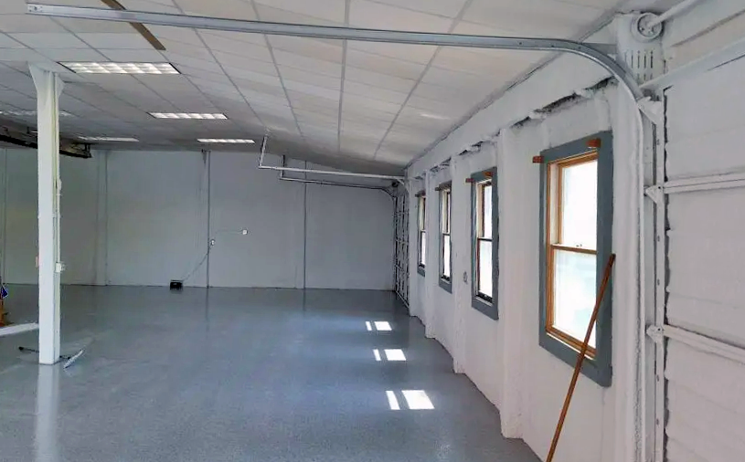 a large empty room with a broom on the floor