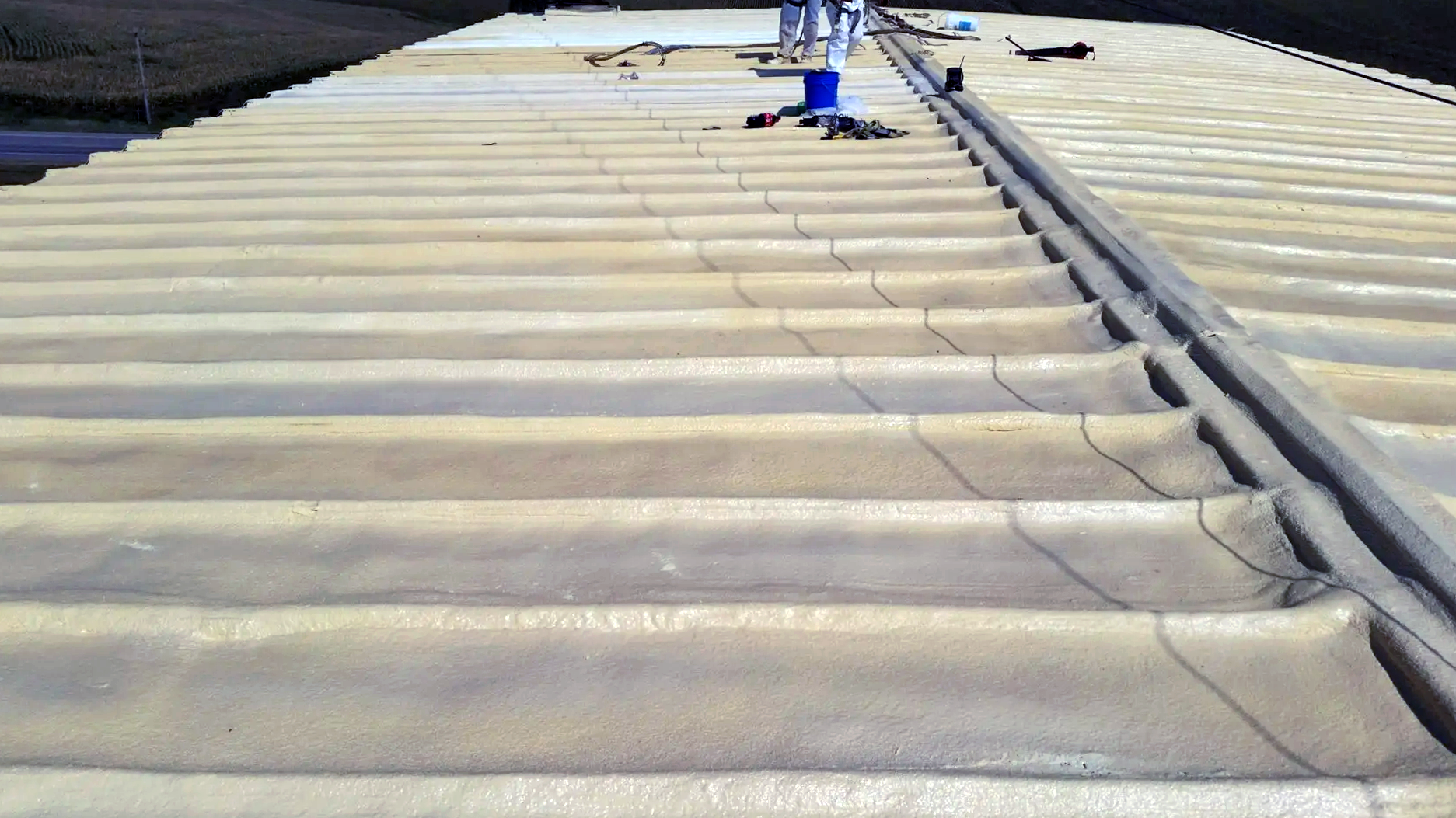 a close up of a roof with a blue pipe on it
