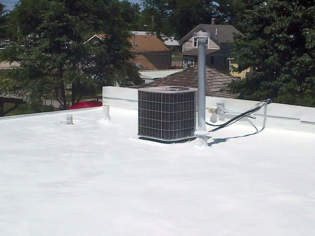 an air conditioner is sitting on top of a white roof