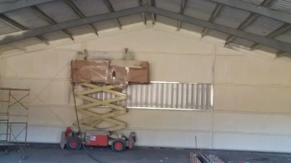 a scissor lift is sitting in the middle of a large building