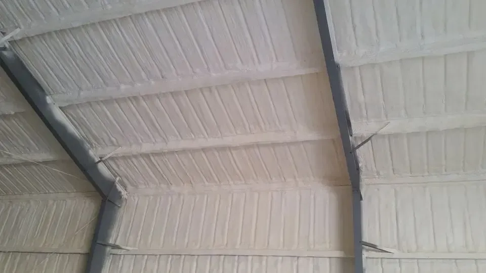 the ceiling of a building is covered in white spray foam .