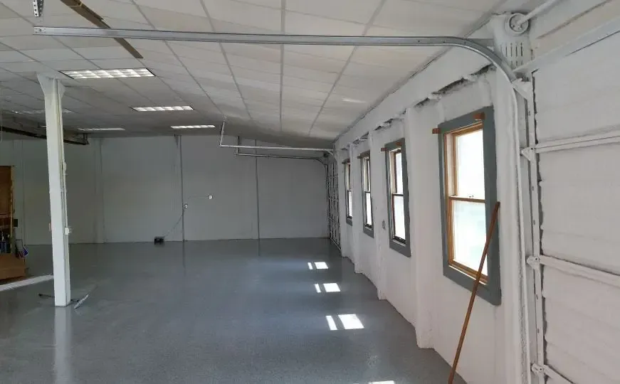 a large empty room with a broom in it