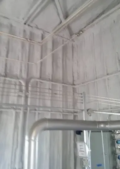 a room with a lot of pipes on the wall and ceiling