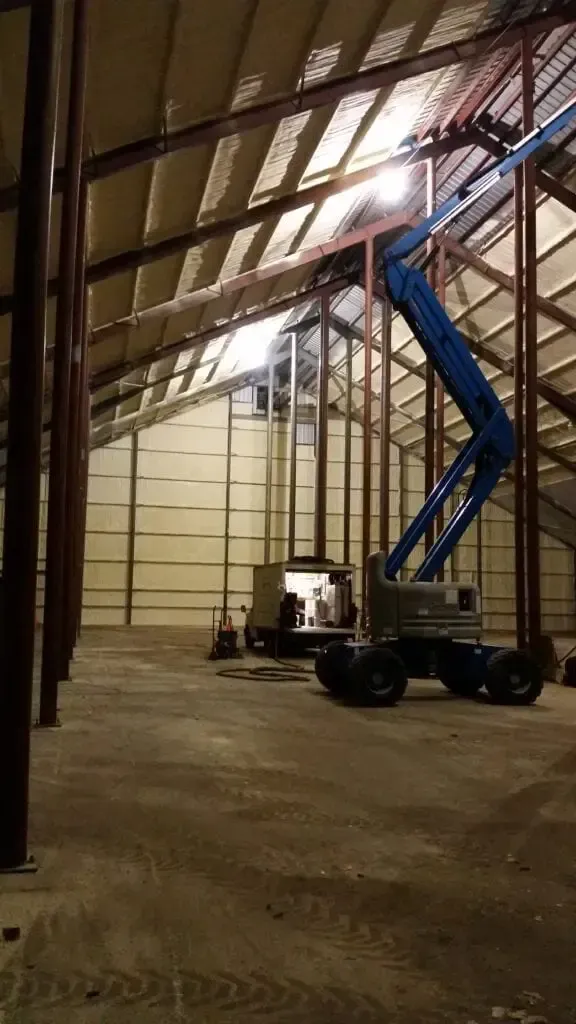 a large warehouse with a crane in the middle of it