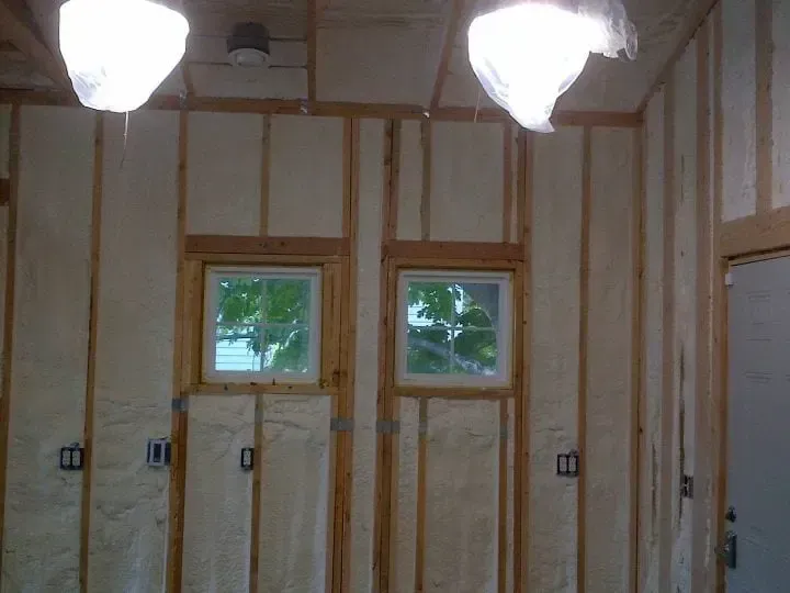 a room with a lot of insulation on the walls and two windows