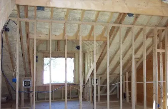 a room that is being built with wooden beams and a window