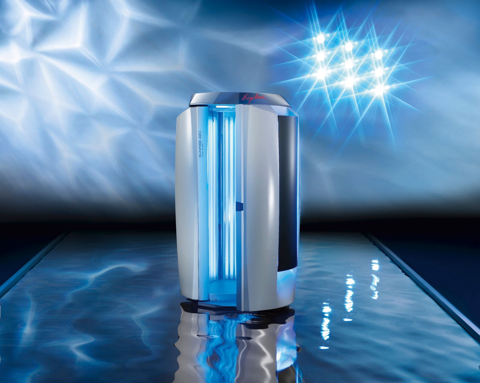 Silver futuristic appliance with blue lighting on a reflective surface, against a glowing blue backdrop