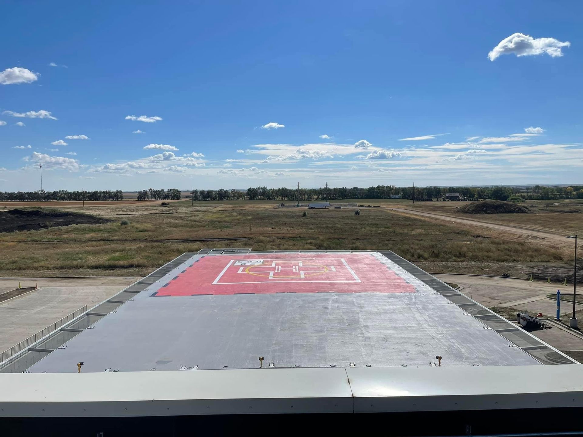 A red and white helicopter landing pad on top of a building.