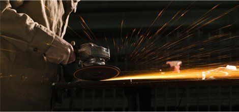 Steel grinder working in metal