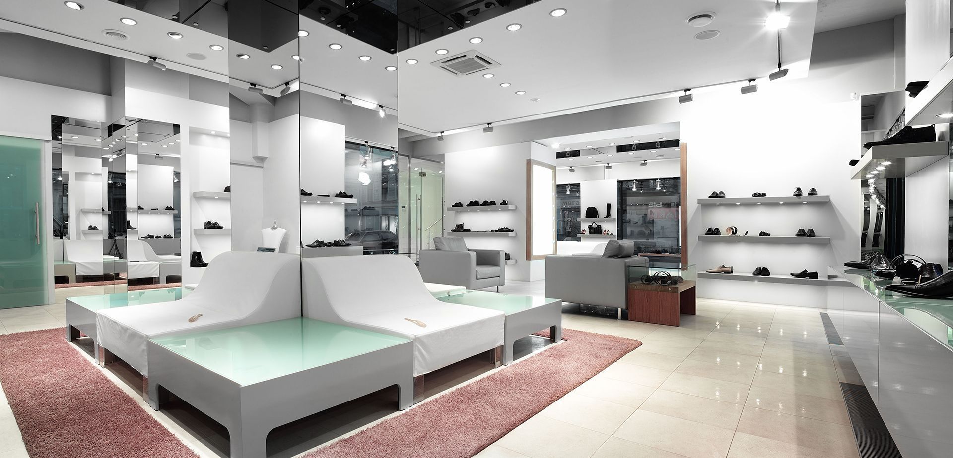 A shoe store with a lot of shelves and tables