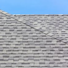 A close up of a roof with a blue sky in the background.