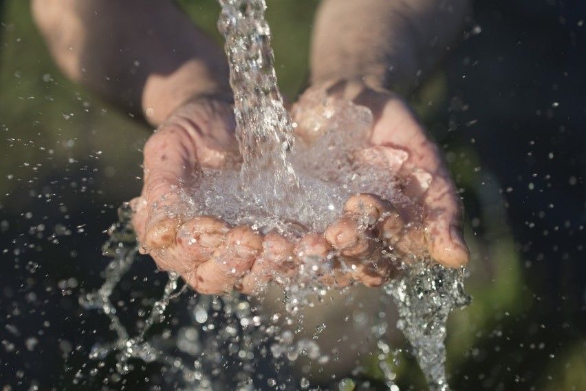 splashing water on hand