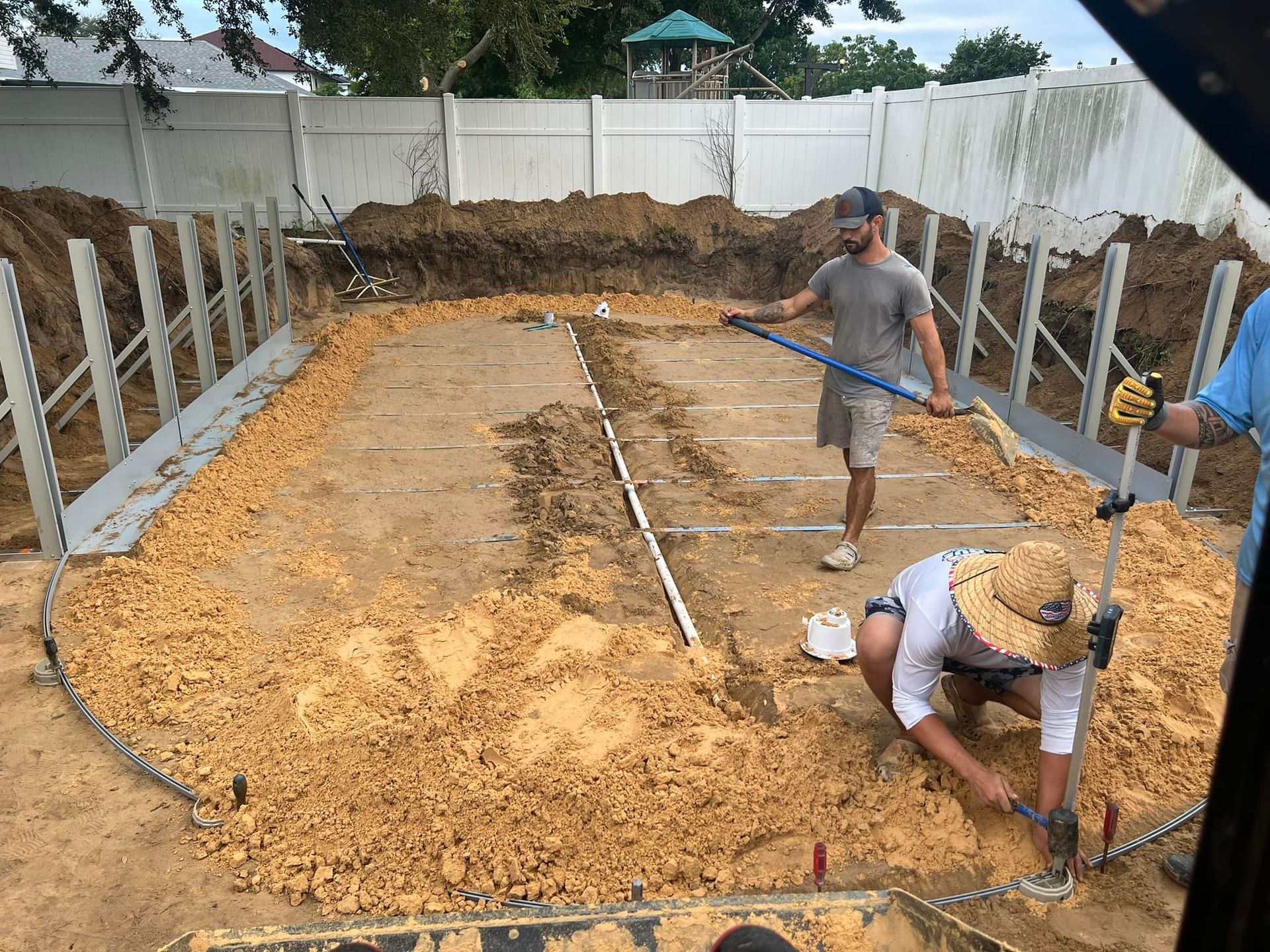 A group of men are working on a swimming pool.