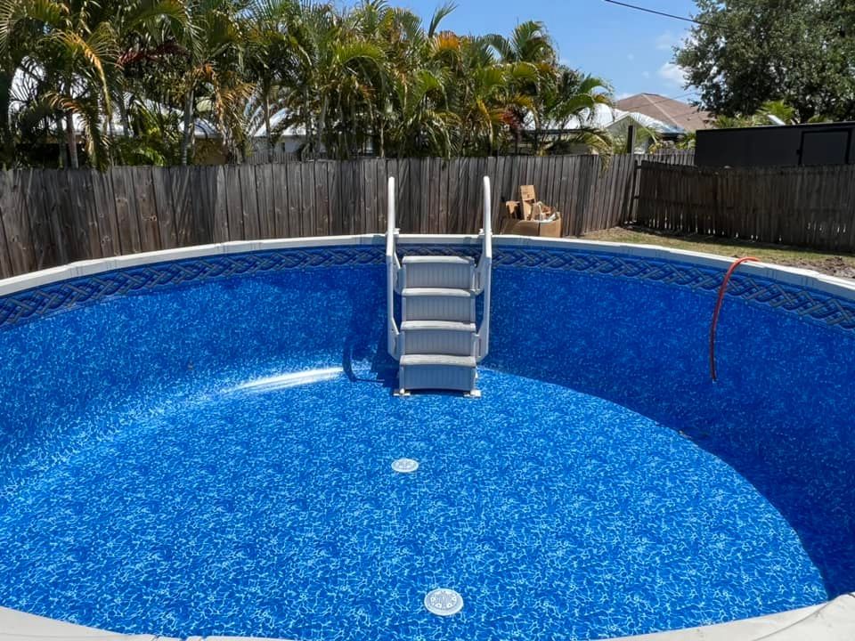 A swimming pool with a ladder in the middle of it.