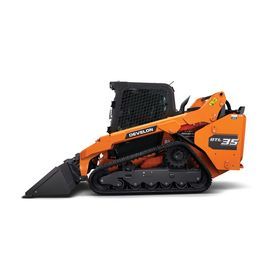 Orange compact track loader with front bucket on a white background