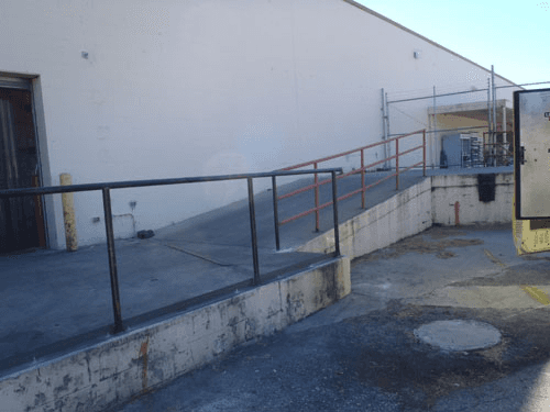 A ramp leading up to a building with a railing