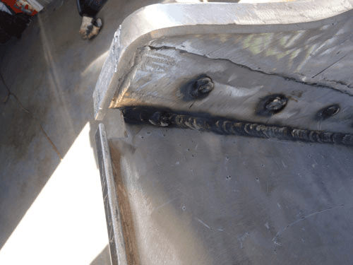 A close up of a piece of metal with a few holes in it