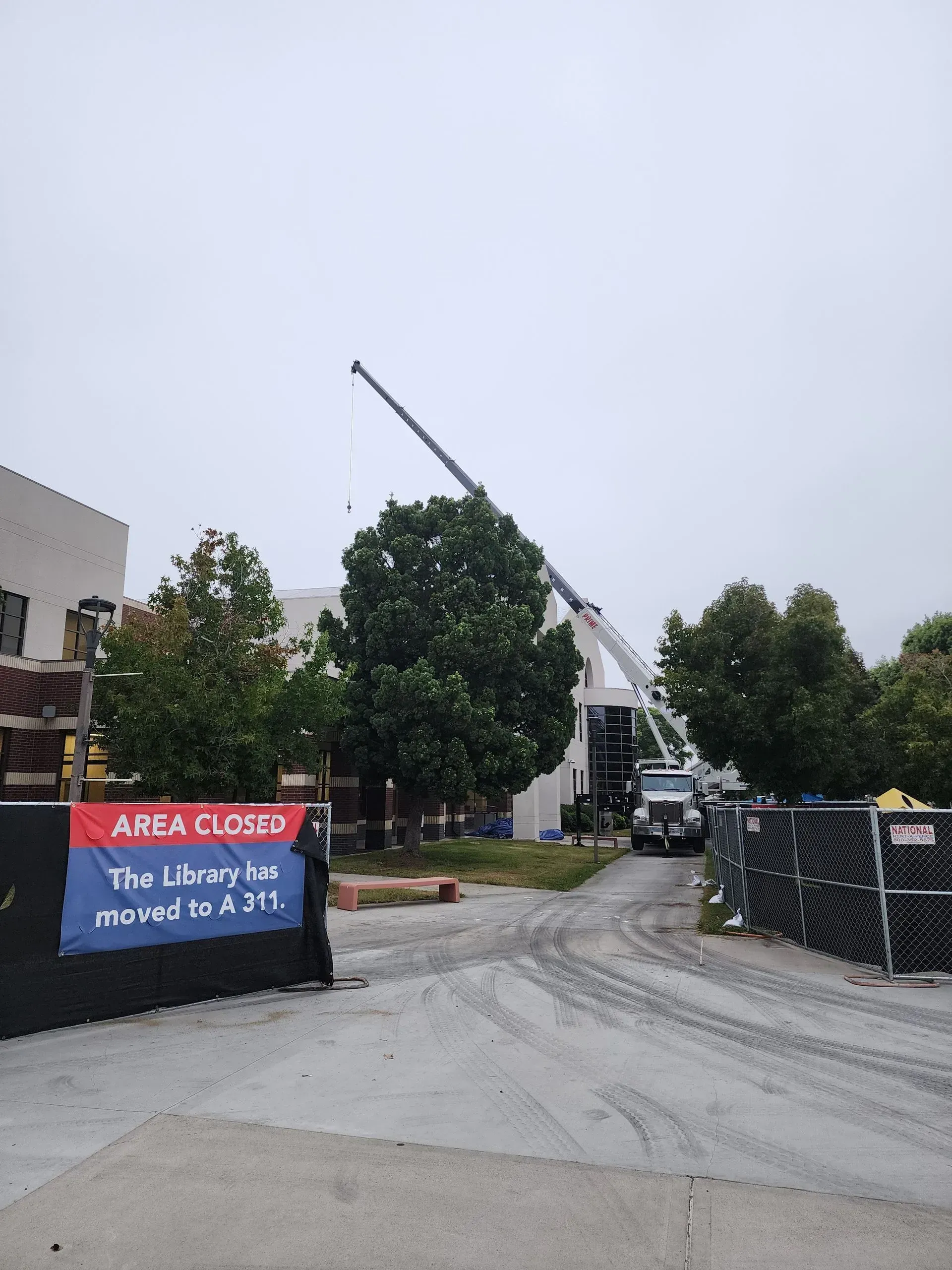Construction site with a crane; the library is closed and being relocated.