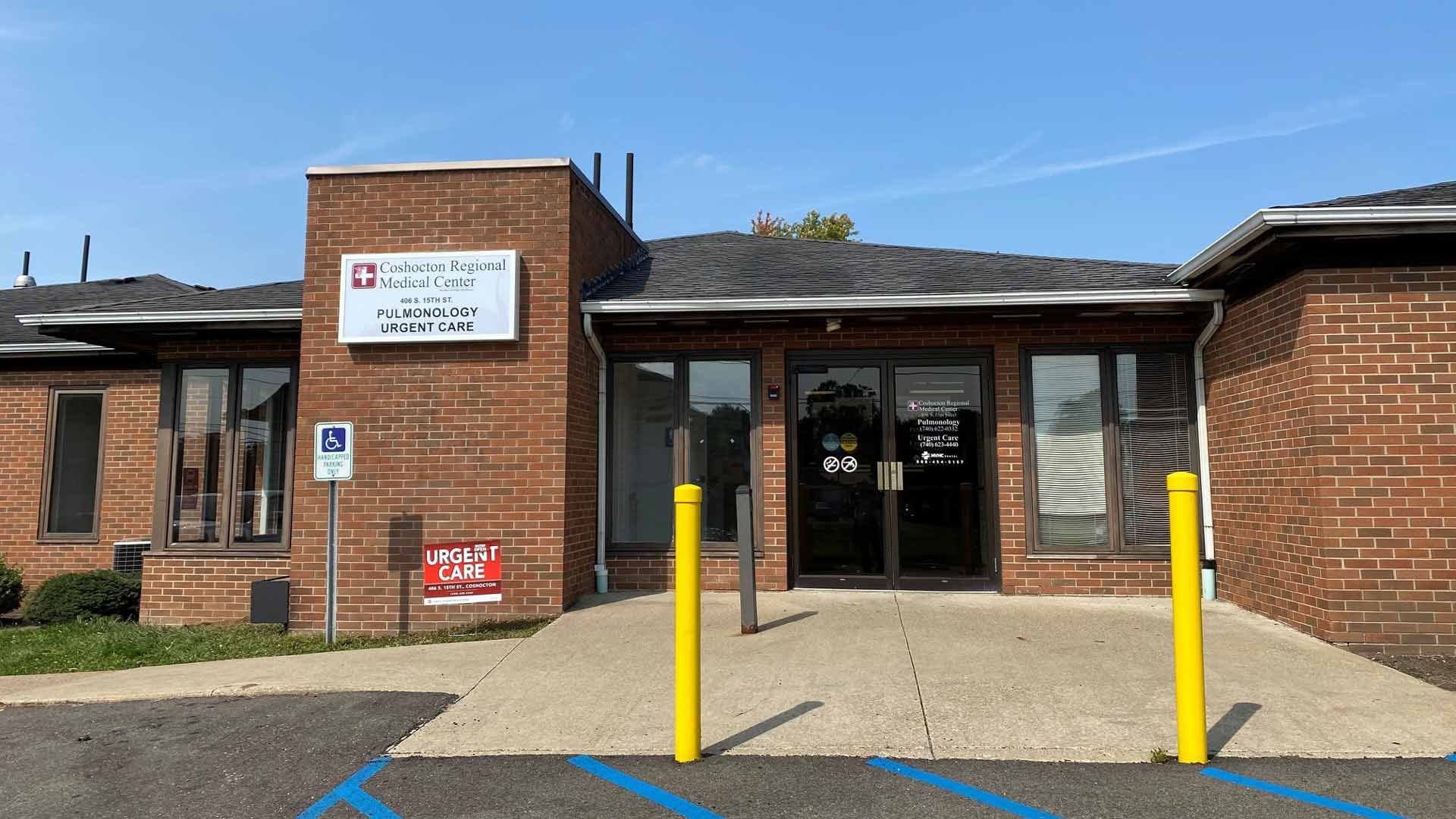 Brick building with entrance, sign for 