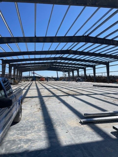 A truck is parked in front of a building under construction