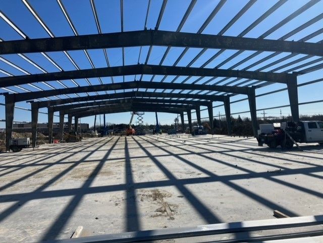 A large building under construction with a blue sky in the background