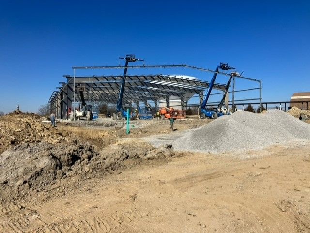 A building under construction with a pile of gravel in front of it