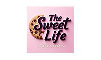 Logo for The Sweet Life with a chocolate chip cookie and text on a pink background.