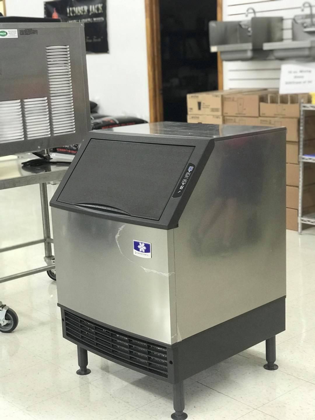 Stainless steel ice machine in a commercial setting.