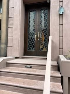 There are stairs leading up to the front door of a building.