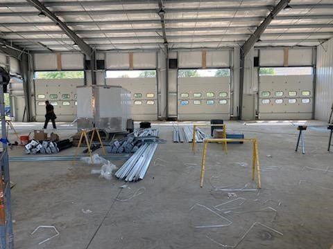 A large warehouse with a lot of pieces of metal on the floor.