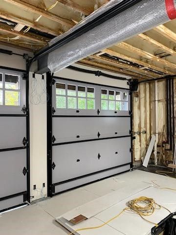 A garage door is being installed in a house.