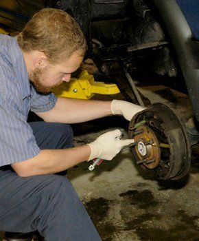 Mechanic working on a car's brakes