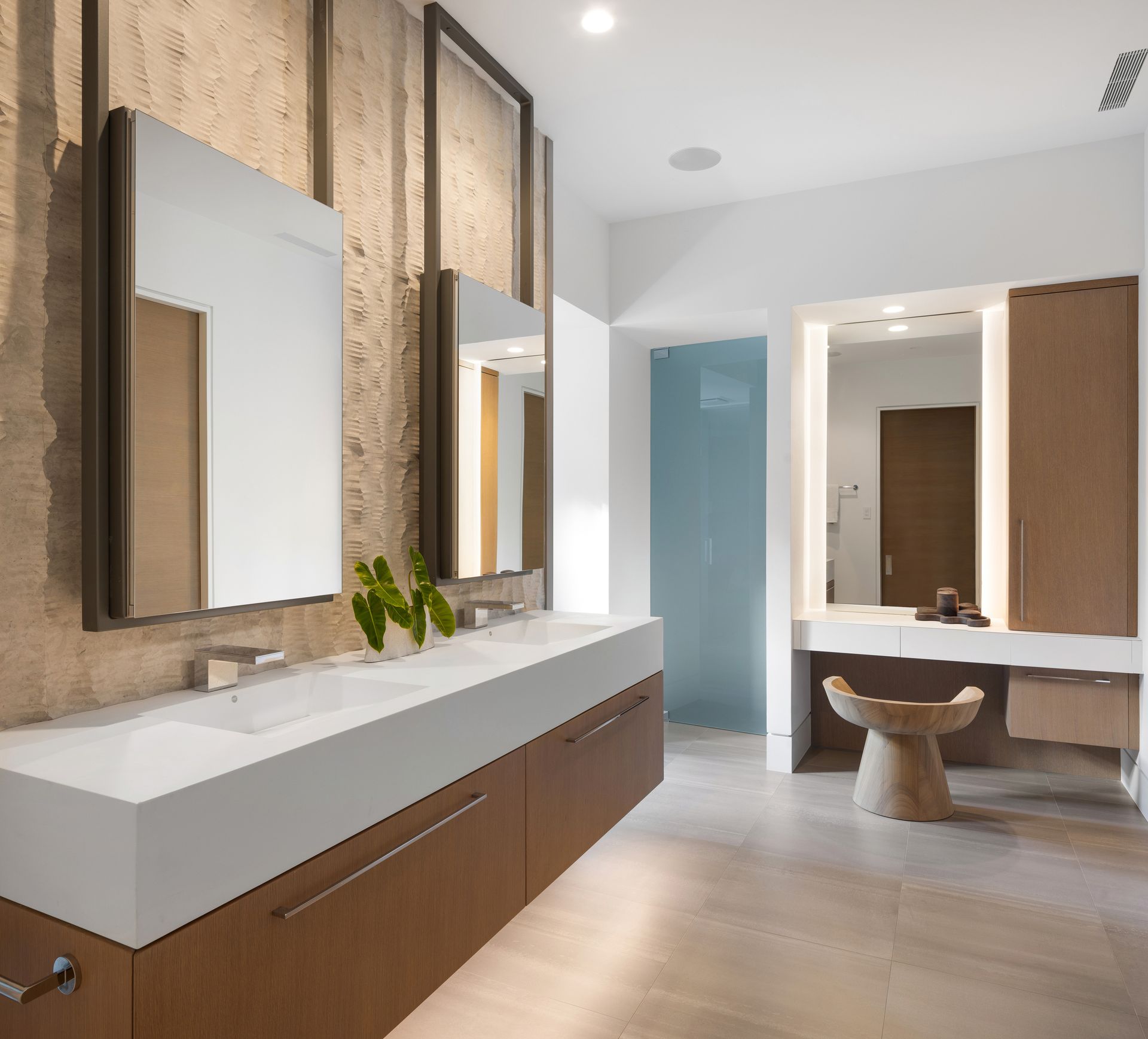 Modern bathroom with a double vanity, mirrors, and a neutral color palette.