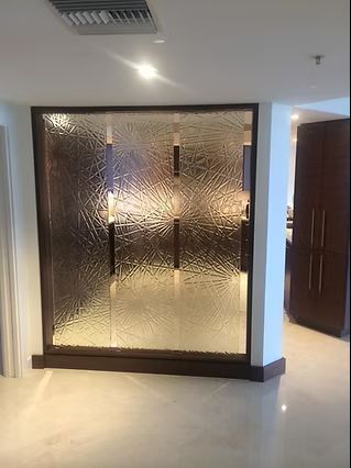 Glass room divider with textured surface set in a dark wooden frame.