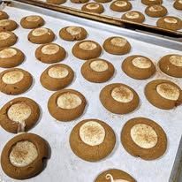 A bunch of cookies are sitting on top of a baking sheet.