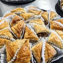 A close up of a plate of baklava on a table.