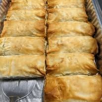 A close up of a tray of food with a fork in it.