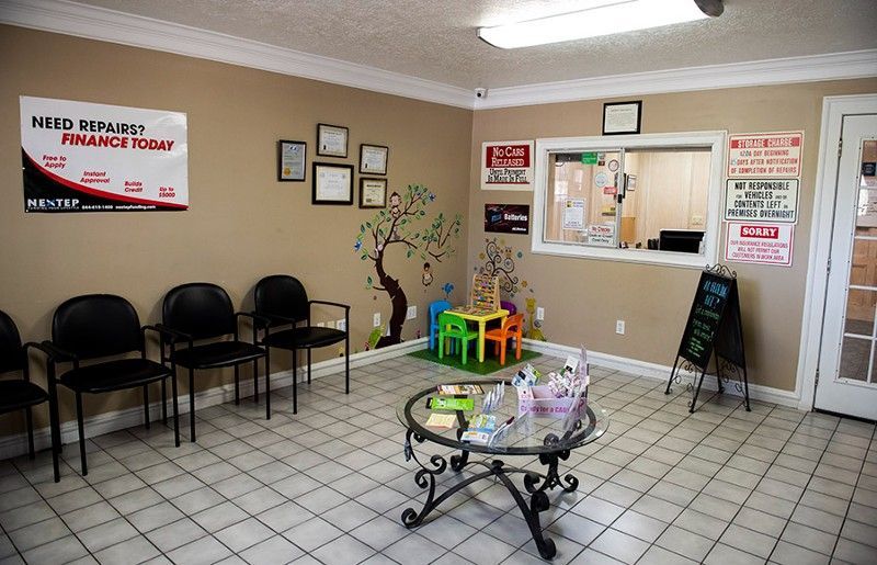 A waiting room with a table and chairs in it