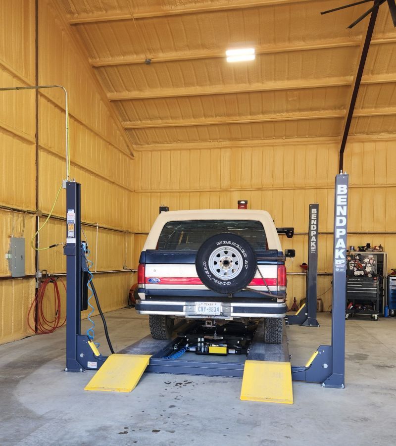 A truck is on a lift that says berkpak