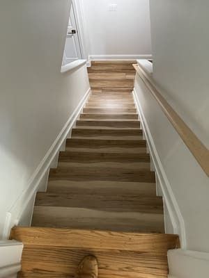 A set of wooden stairs leading up to the second floor of a house.