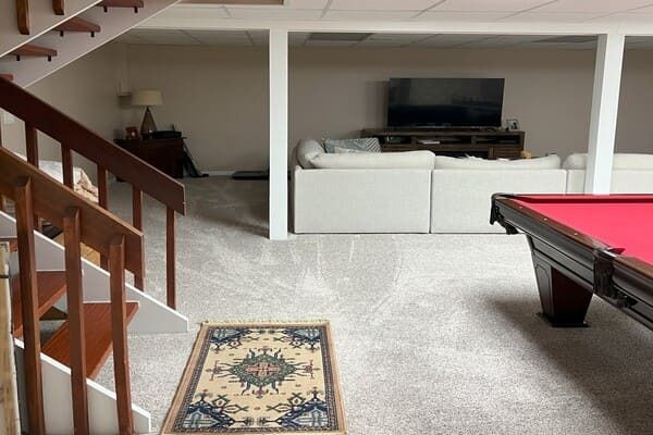 A pool table in the middle of a living room