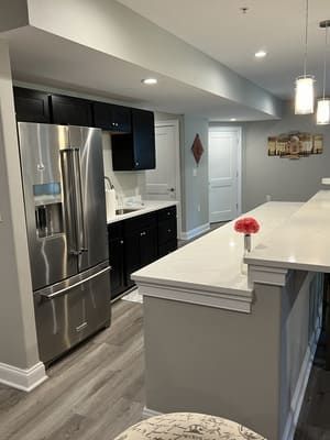 A kitchen with stainless steel appliances and a large island.