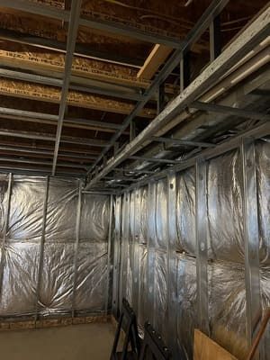 A room with a metal frame and foil on the walls.