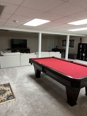 There is a pool table in the middle of the room.