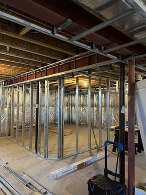 A basement under construction with a lot of metal frames.