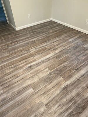 A room with a wooden floor and white walls.