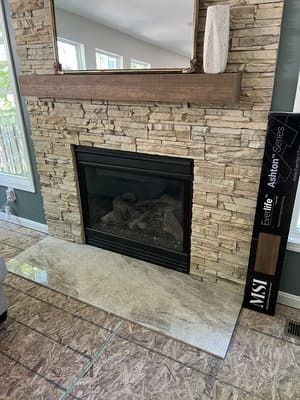 A living room with a fireplace and a mirror.