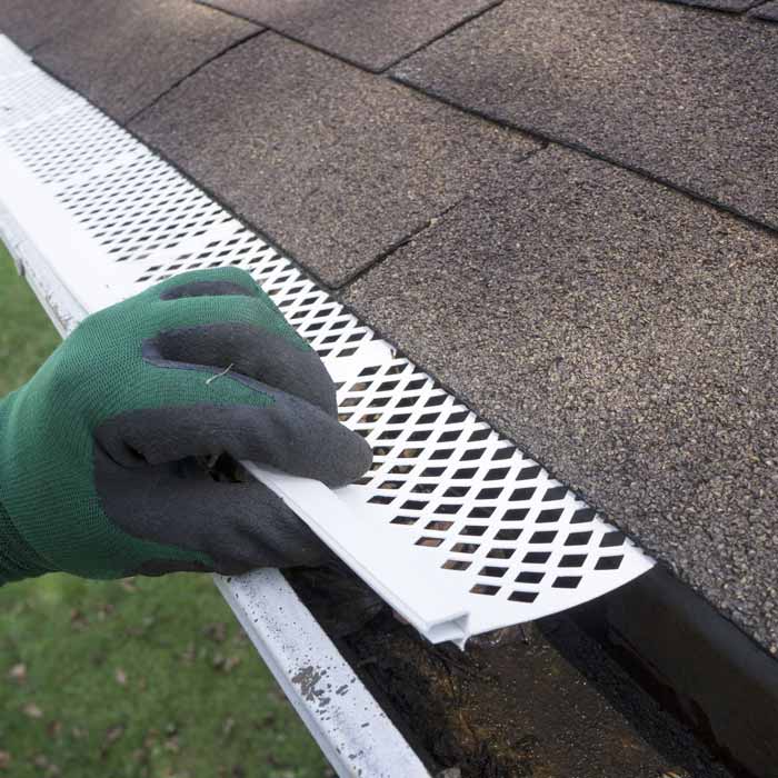 Contractor checking installation of plastic leaf guards