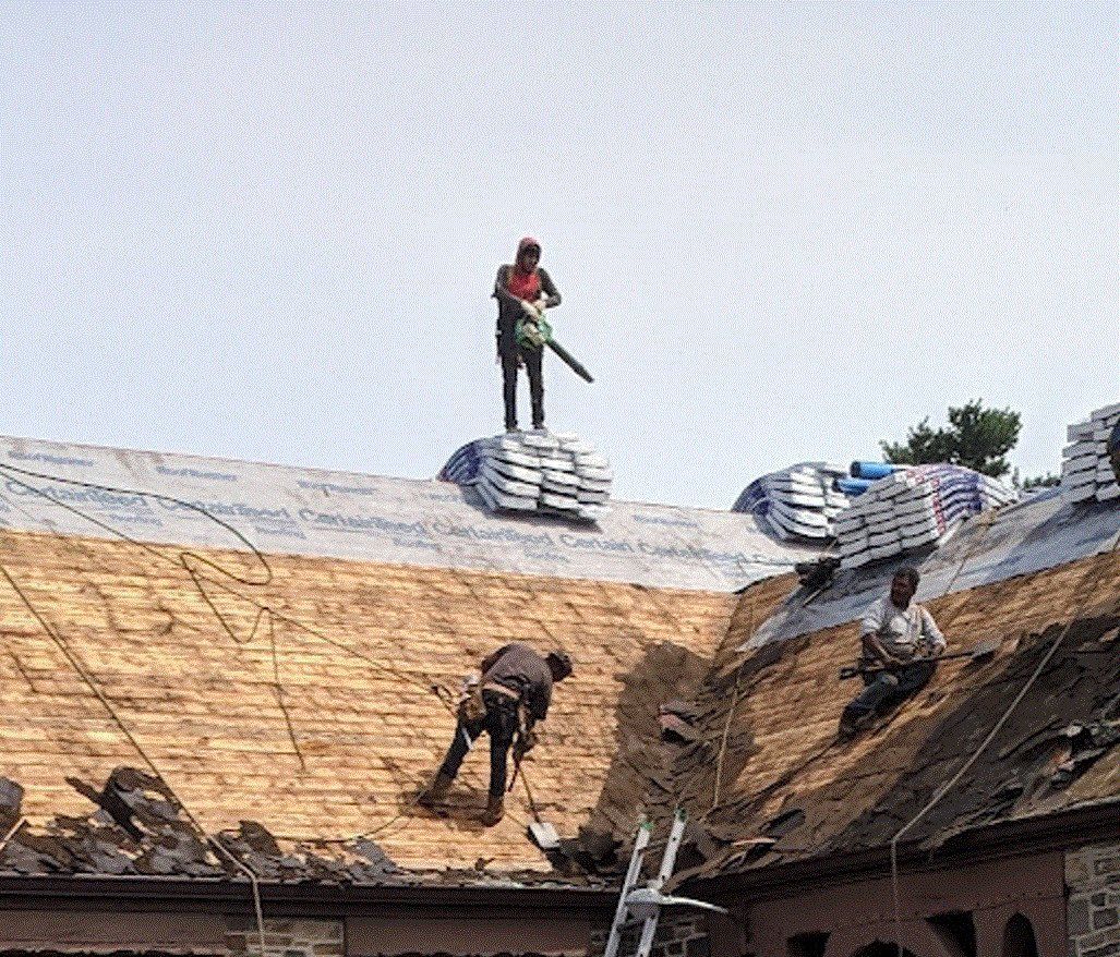 Workers installing new roof