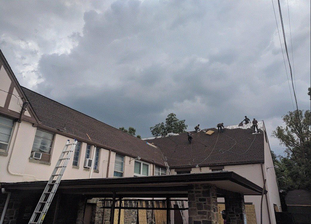 Workers installing roof on a commercial building